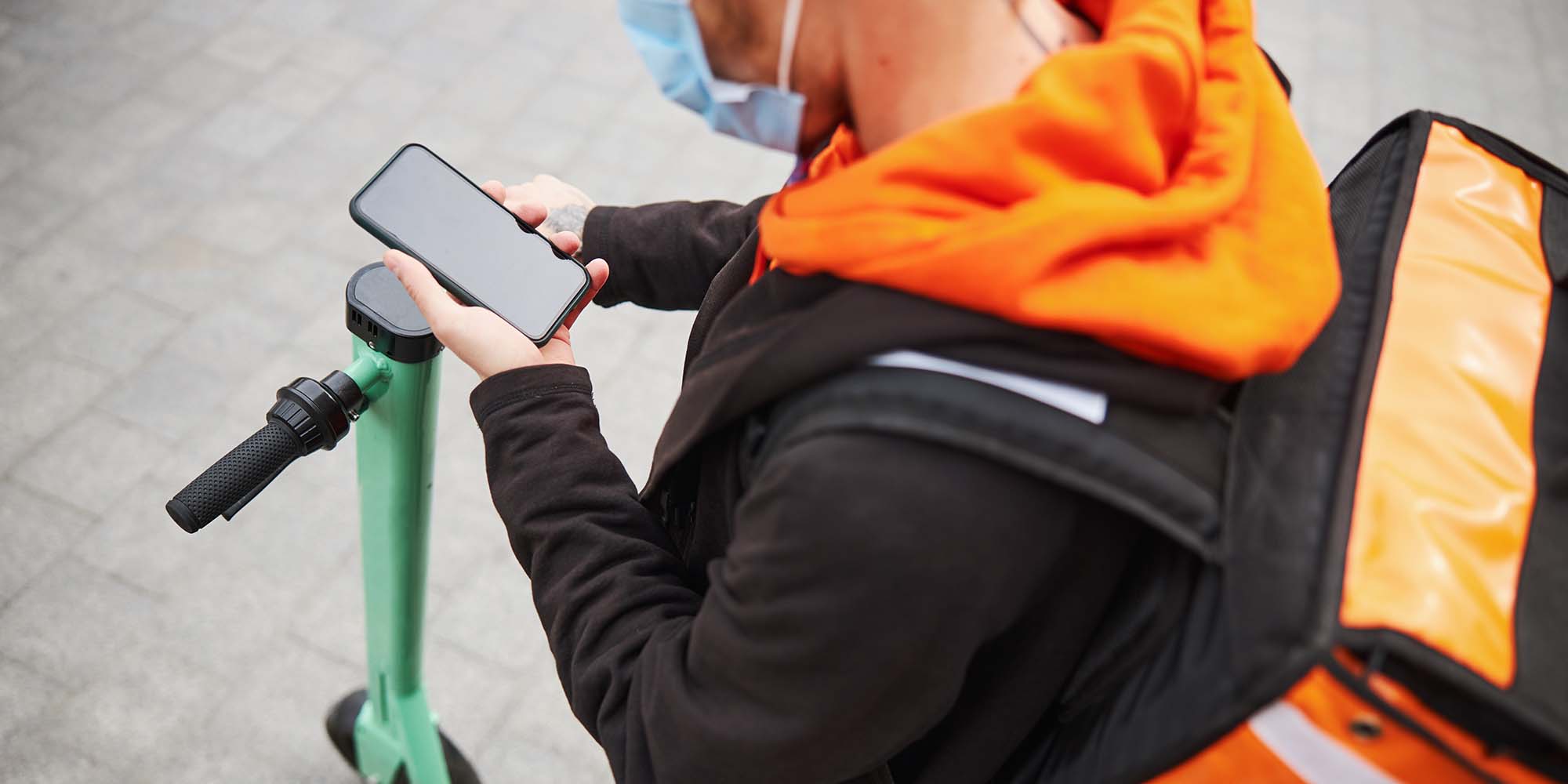low-angle-photo-of-young-courier-renting-scooter-DPZMDTQ.jpg